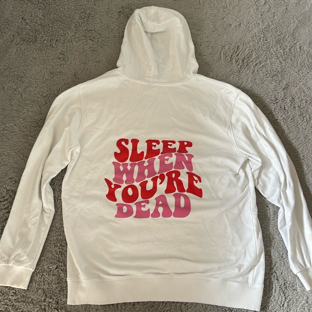 White hoodie with quote on back